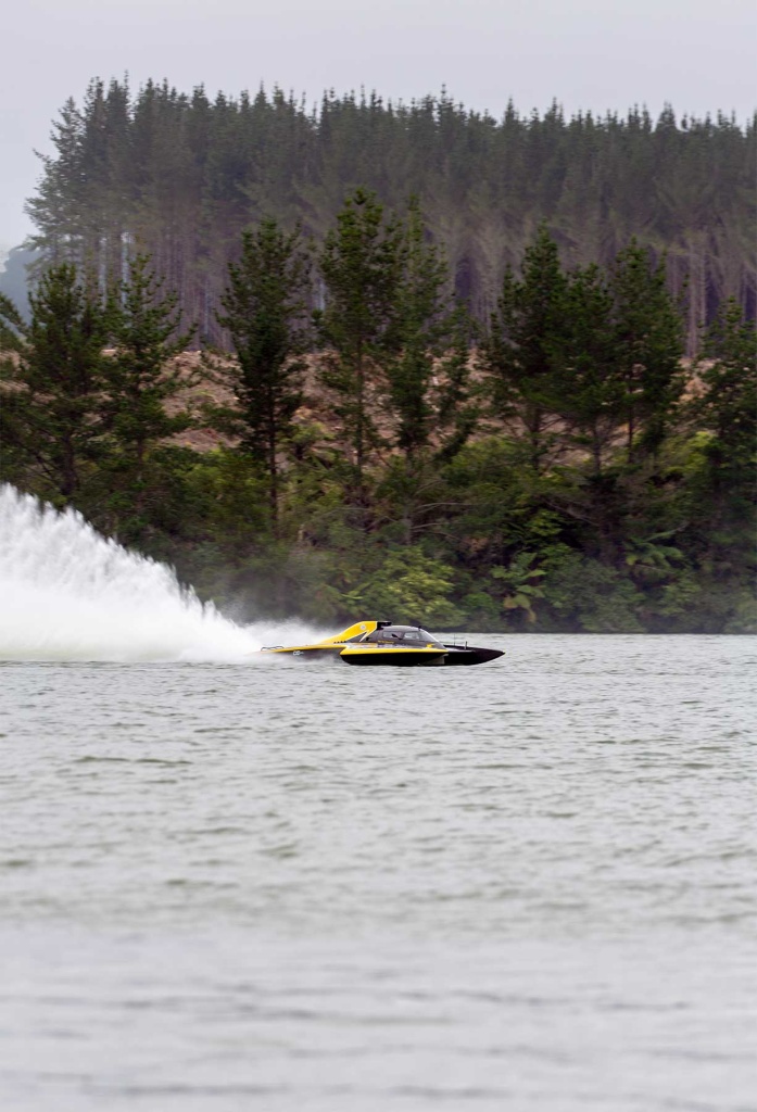 A hydroplane racing past some trees at Lake Maraetai